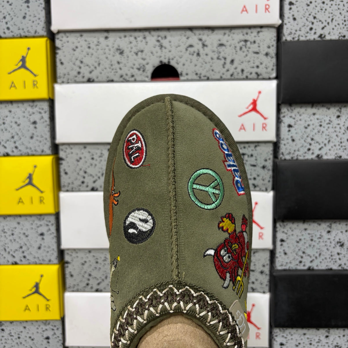 UGG × Palace Skateboards Tasman Slipper – Olive Suede with Embroidered Graphic Patches & Herringbone Braid Trim