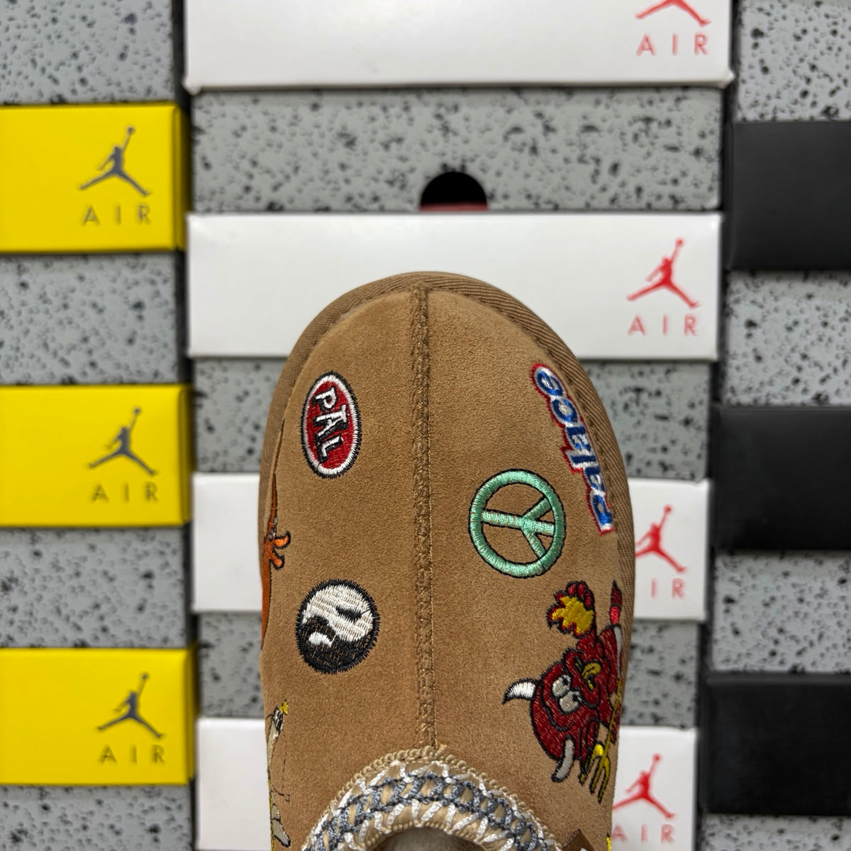 UGG × Palace Skateboards Tasman Slipper – Chestnut Suede with Embroidered Graphic Patches & Metallic Braid Trim