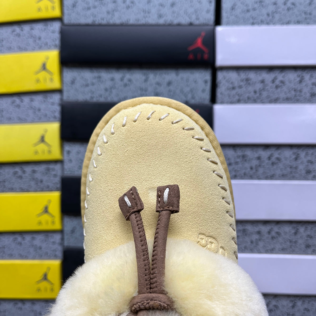 UGG Coquette Stitch – Maize Suede Open-Back Slipper with Sheepskin Cuff & Gold Logo Charm